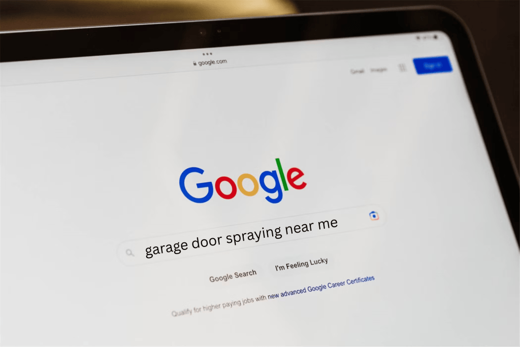 A Google search on a laptop for garage door spraying near me