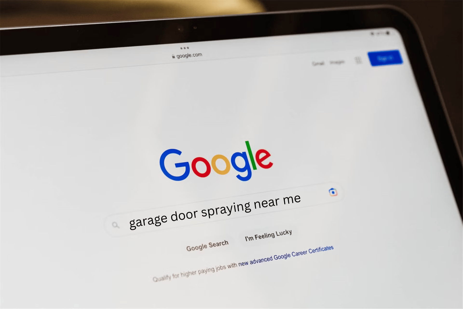 A Google search on a laptop for garage door spraying near me