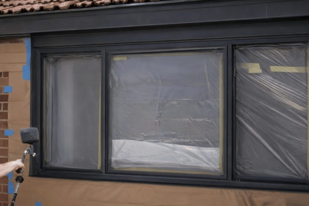 A window that has been taped up and sprayed black in Cardiff