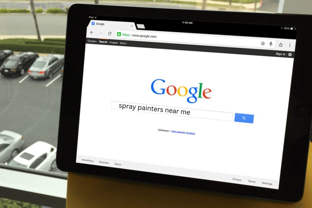 Someone searching for spray painters near me on their iPad